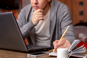 person taking notes at a computer